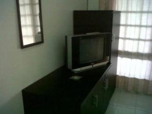 a flat screen tv sitting on a dresser in a room at Griya Palayu in Bogor