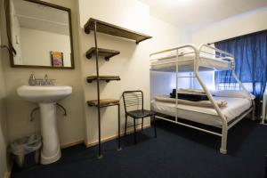 a bathroom with a bunk bed and a sink and a mirror at American Dream in New York