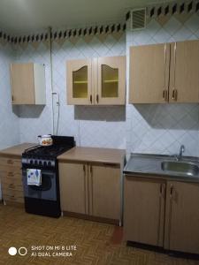 a kitchen with a stove and a sink at 1-ная квартира по адресу Глушко 28 in Odesa