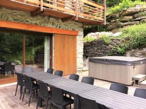 a large wooden table and chairs on a patio at Ferme Saint-Aubin in Sainte-Foy-Tarentaise