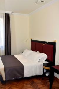 Ένα ή περισσότερα κρεβάτια σε δωμάτιο στο Torrione Hotel