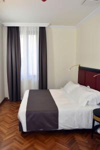 Postel nebo postele na pokoji v ubytování Torrione Hotel