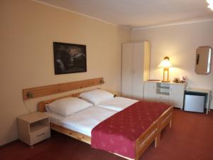 a bedroom with a large bed with a red blanket at Pensjonat Willa Edyta in Mrągowo +51 photos