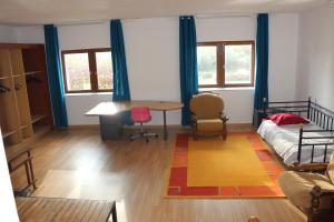 a living room with a bed and a table at Locations de la centrale de Belleville in Neuvy-sur-Loire