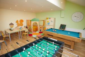 a childs play room with a pool table at Strublhof in Rettenberg