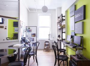 a room with chairs and a table with a computer at American Dream in New York