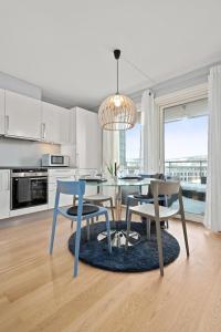 a kitchen with a dining table and two chairs at BJØRVIKA APARTMENTS, Solsiden Area, Trondheim city center in Trondheim