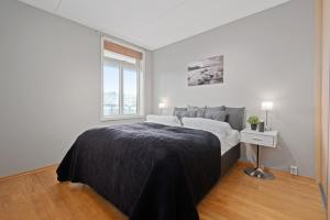 En eller flere senge i et værelse på BJØRVIKA APARTMENTS, Solsiden Area, Trondheim city center