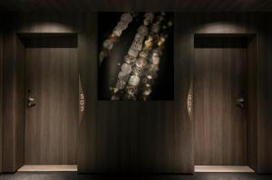 two brown doors with a picture on the wall at La Clef Champs-Élysées Paris by The Crest Collection in Paris