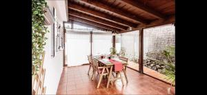 a room with a table and chairs on a balcony at Casa Cora Con Jacuzzi in Breña Baja