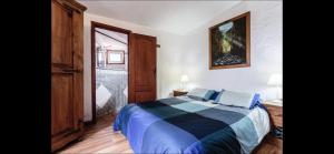 a bedroom with a bed with blue sheets and a window at Casa Cora Con Jacuzzi in Breña Baja
