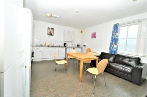 a kitchen and a living room with a table and a couch at The Waterfront in Greenock