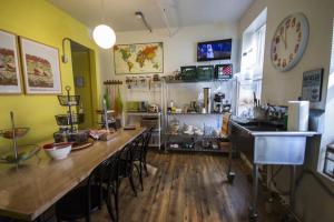 a kitchen with a long table with chairs and a sink at American Dream in New York