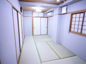 an empty room with white walls and windows at Central Field 5-6F in Tokyo