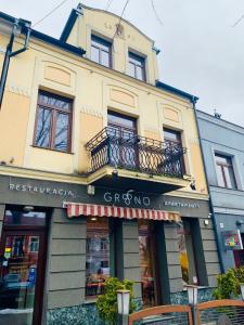 a store front of a building with a balcony at GRONO Apartamenty in Częstochowa