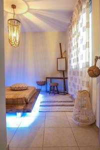 a bedroom with a bed and a table in a room at Relux Apartment in Agios Nikolaos