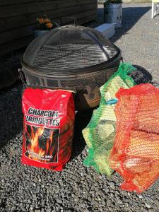 a grill and two bags of food sitting next to it at Cosy Camping Suffolk in Ipswich