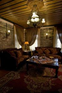 a living room with a couch and a table at Archontiko Geki 1876 in Papingo