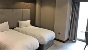 
Cama o camas de una habitación en Ten Square Hotel
