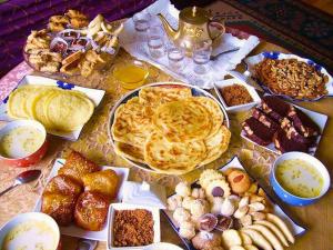a table topped with different types of pastries and desserts at Apartamento El Mirador in M'diq