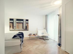 a white living room with a couch and a table at THE QVEST hideaway in Cologne
