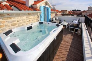 a large hot tub on a balcony of a house at Villa Vito in Bibinje