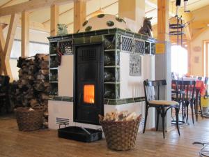 a wood stove in a room with a table at Brand-Baude in Hohnstein