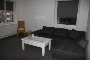 a living room with a couch and a coffee table at Andrea in Lübeck