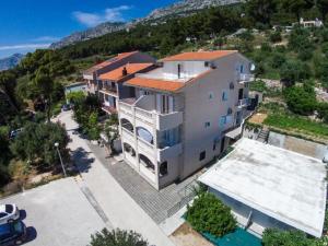 an aerial view of a large house with a parking lot at Apartments SKY in Brela