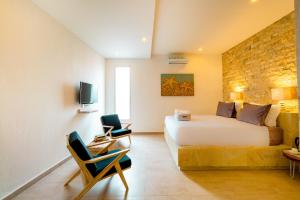 TV a/nebo společenská místnost v ubytování Cocotoa Boutique Hotel & Villa