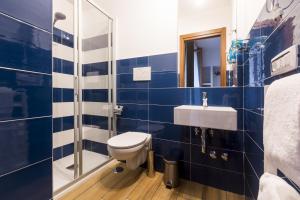 a blue and white bathroom with a toilet and a sink at Central Plaza Sorrento Coast in Sant'Agnello