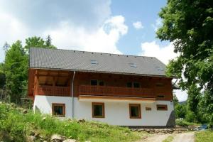 a large wooden house with a roof at Rekreačná chata Luna in Liptovská Sielnica