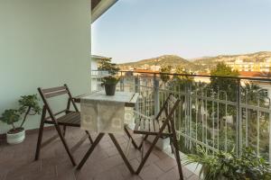 a table and chairs on a balcony with a view at Central Plaza Sorrento Coast in Sant'Agnello