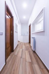 an empty hallway with wooden floors and a door at Central Plaza Sorrento Coast in Sant'Agnello