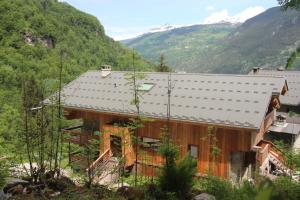 a house with a metal roof on a mountain at Ferme Saint-Aubin in Sainte-Foy-Tarentaise