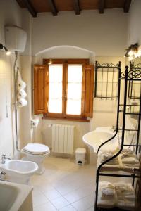 a bathroom with a toilet and a sink at Podere Fichereto Tuscany apartment in Florence countryside in Scandicci