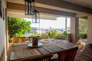 a wooden table and chairs on a deck with a view at Relux Apartment in Agios Nikolaos
