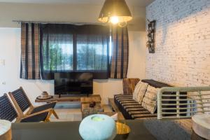 a living room with a couch and a table at Relux Apartment in Agios Nikolaos