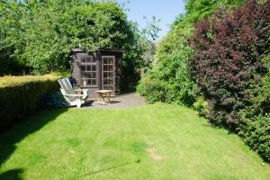 a garden with a bench and a table in the grass at 2 Hope Cottage in Spilsby