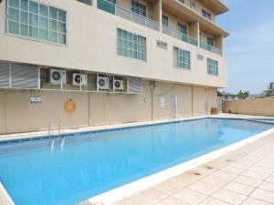 a swimming pool in front of a building at Mayfair Hotel in Dar es Salaam