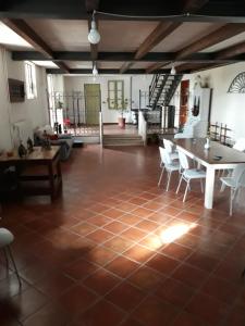 a living room with a tiled floor and a table and chairs at Agriturismo Cipolli e Podò Corte Carlini in Mantova