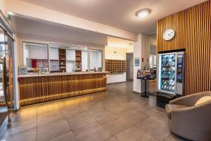 a store with a cash register and a clock on the wall at Thermotel in Dax