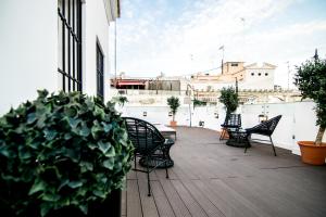 a wooden bench sitting in front of a patio at Marqués House Hotel 4* Sup in Valencia