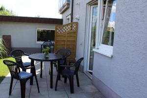 a table and chairs sitting on a patio at Pension Boitz in Rust