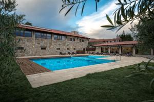 a swimming pool in front of a building at Quinta do Olival in Vilas Boas