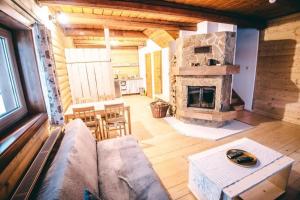 a living room with a couch and a fireplace at chalupa matko a kubko in Bravačov