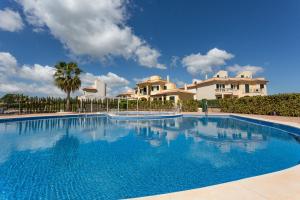 a large swimming pool in front of a house at Residence Club El Paraiso in Sa Ràpita