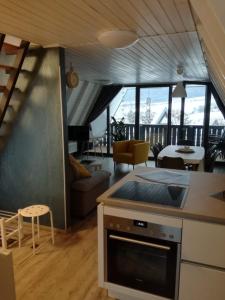 a kitchen and living room with a staircase and a living room at Ferienhaus in der Rhön Sitzmann in Bischofsheim an der Rhön