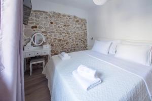 a bedroom with a bed with towels on it at Villa Vito in Bibinje