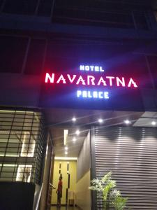 a neon sign for a naughaniana palace in a building at Navaratna Palace in Belgaum